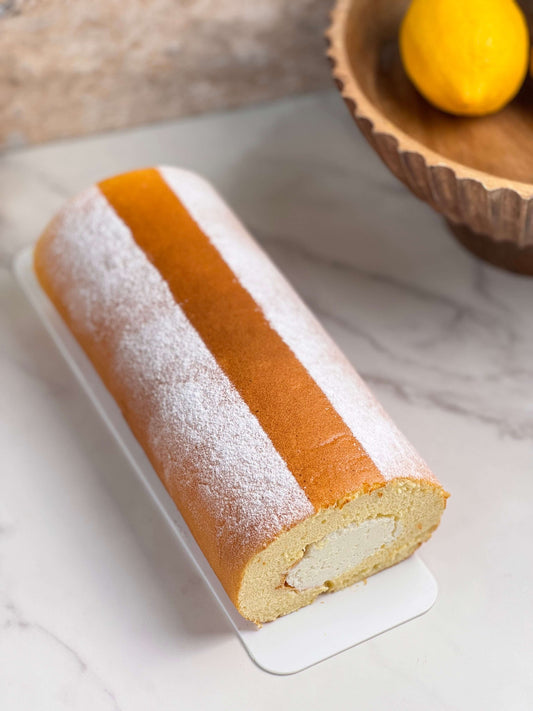 Japanese floating cloud cake roll featuring a fluffy sponge and delicate cream filling on a marble surface.