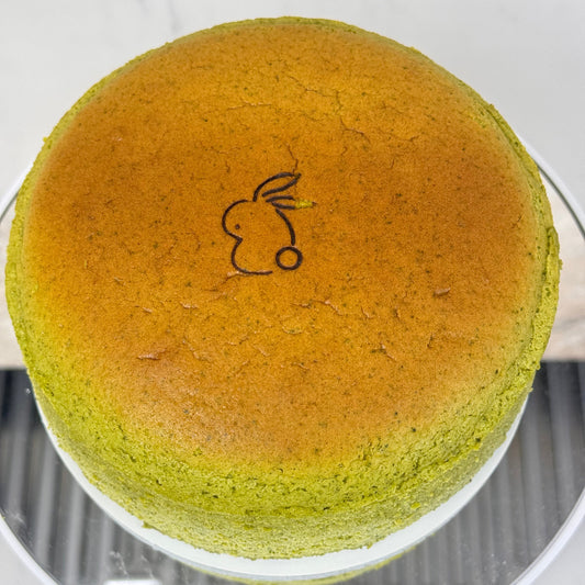 Matcha Japanese Souffle Cheesecake with a cute bunny design on top, showcasing its vibrant green color.