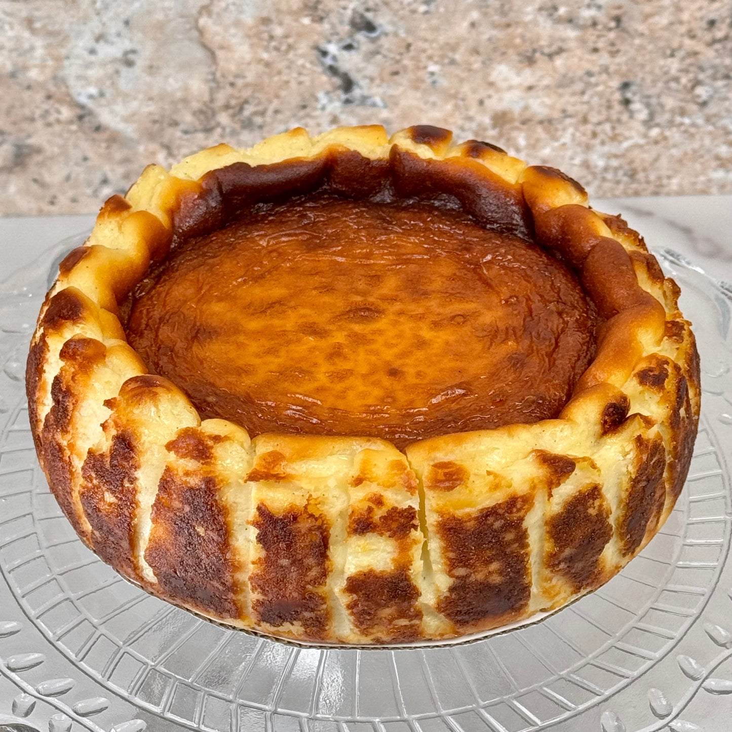 Rich and creamy burnt Basque cheesecake with a caramelized, dark golden crust and a smooth, custard-like center.