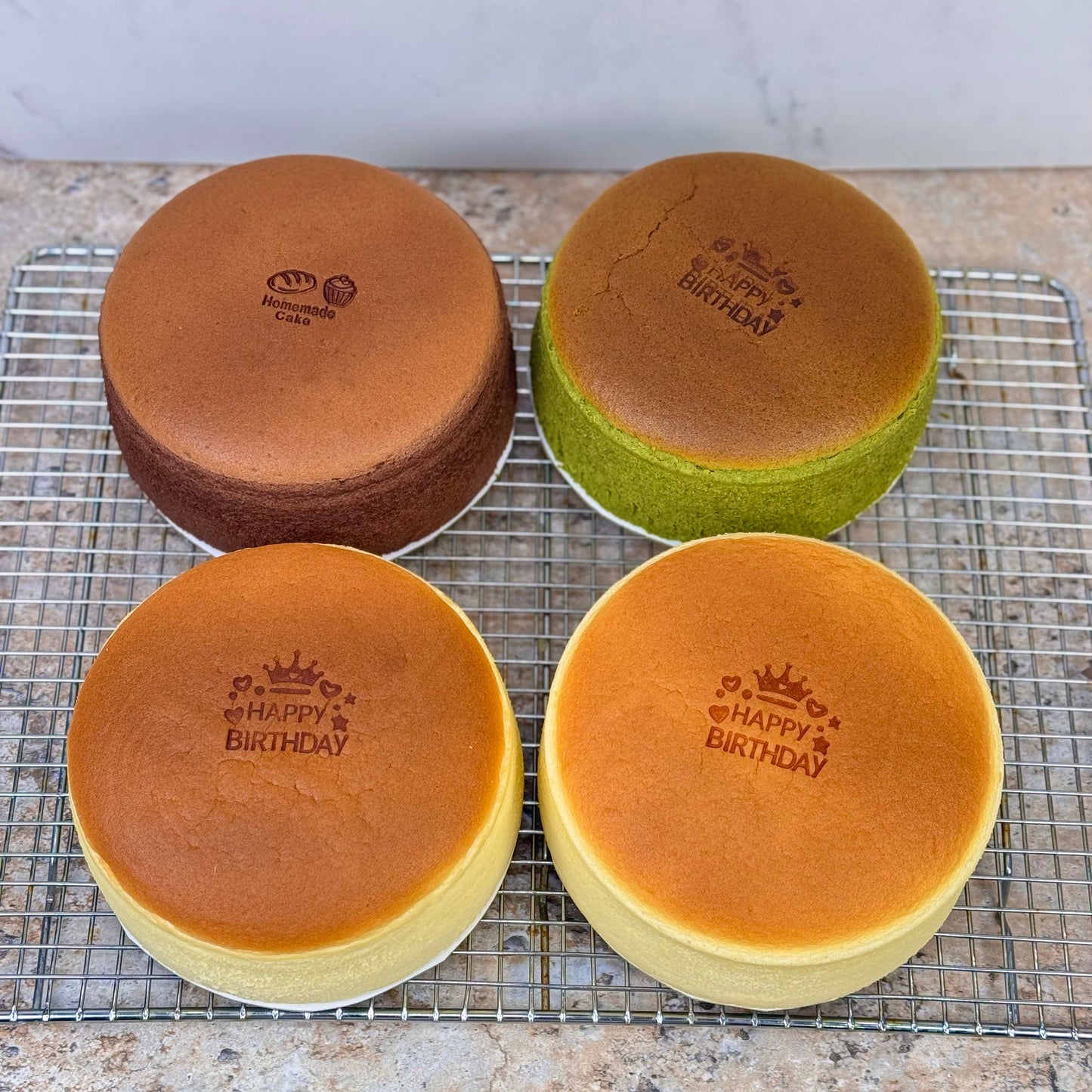 Japanese souffle cheesecake assortment featuring various flavors with birthday decorations.
