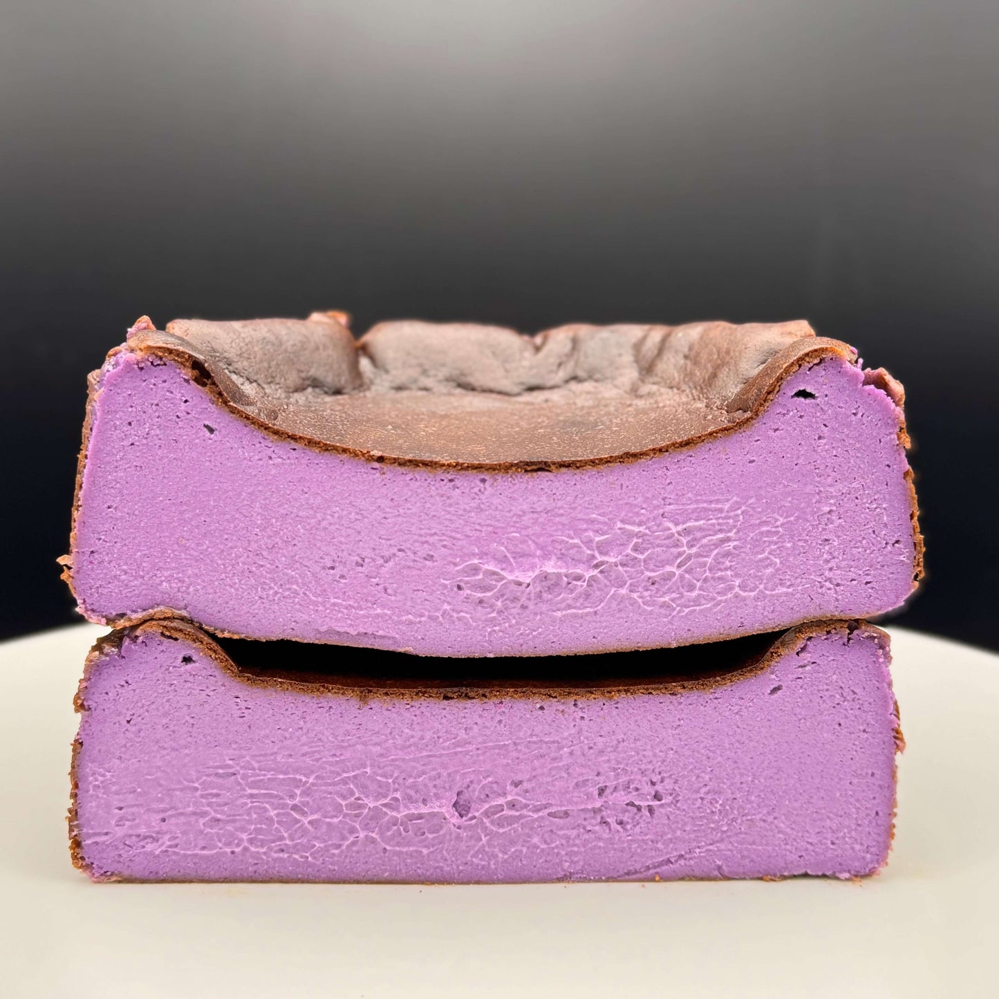 Ube Basque Burnt Cheesecake Gluten Free showcasing its vibrant purple layers and caramelized top.