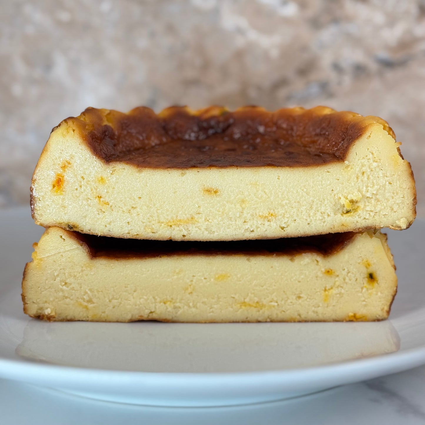 Gluten free passion fruit burnt cheesecake with a caramelized top and creamy texture, served on a plate.