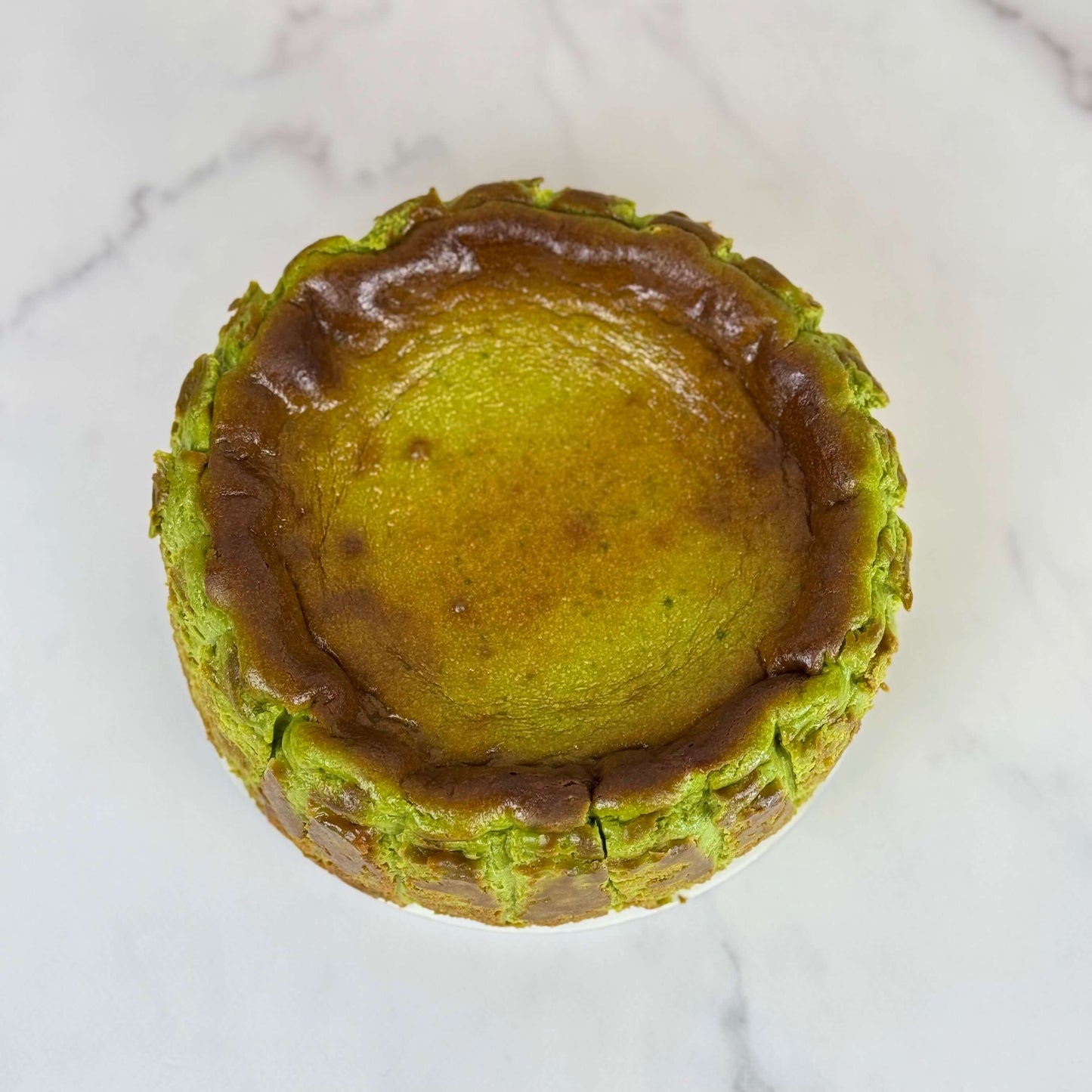 gluten-free matcha Burnt Basque cheesecake 6 Inch with a caramelized top and green matcha exterior.