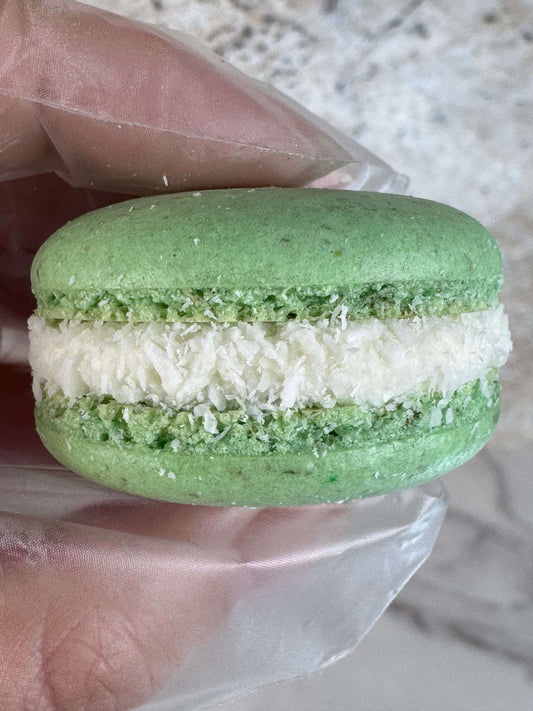 Pandan Coconut Macaron with green almond meringue shell and coconut filling, showcasing tropical flavors.
