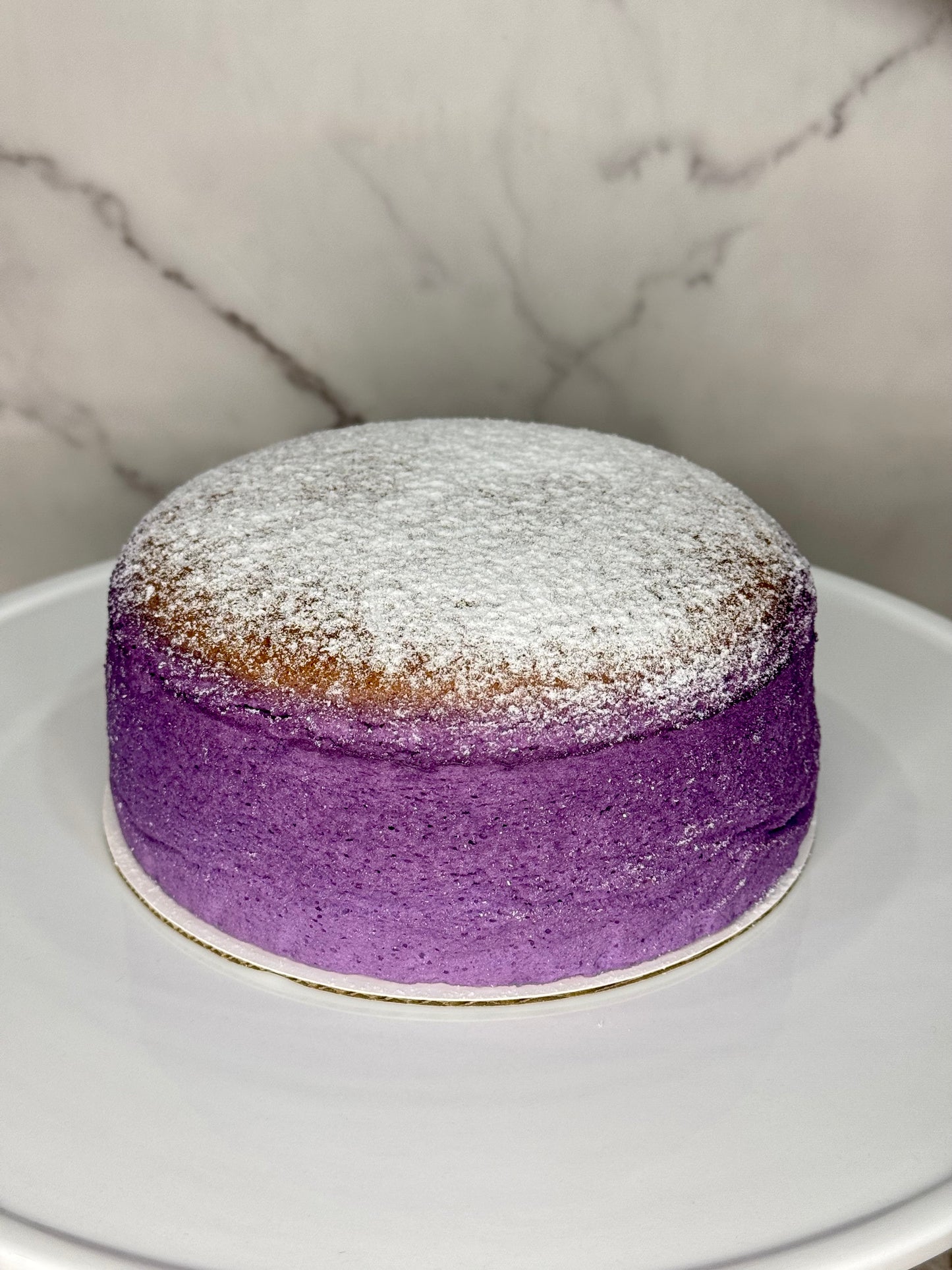 Light, airy Japanese cheesecake infused with vibrant ube purple yam, featuring a soft, jiggly texture and delicate sweetness