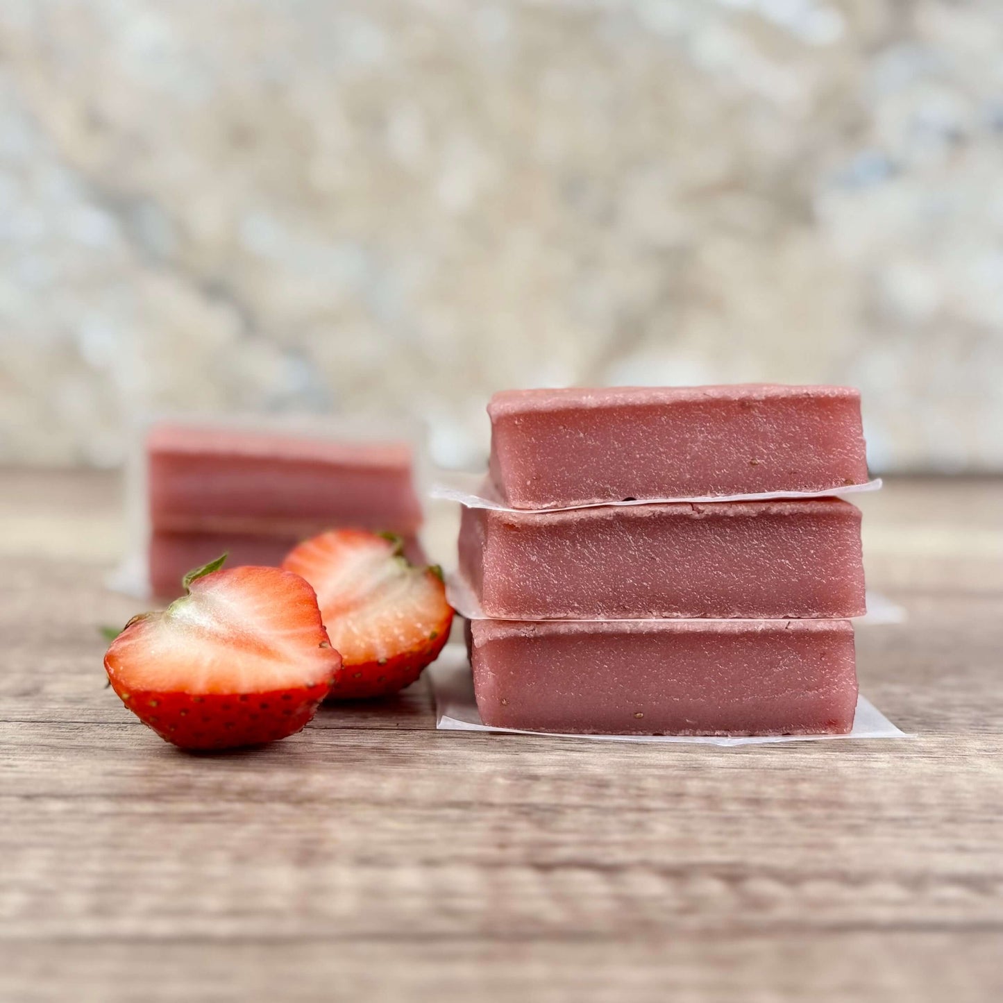 Vegan Strawberry Mochi Cake Bars stacked with fresh strawberries, showcasing their chewy texture and delicious flavor.