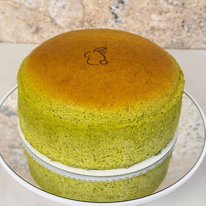 Matcha Japanese Souffle Cheesecake 6 Inch Organic with a smooth green exterior and a bunny logo topping.