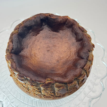 Creamy burnt Basque cheesecake infused with roasted hojicha tea, boasting a caramelized crust and a smooth, earthy-flavored center.