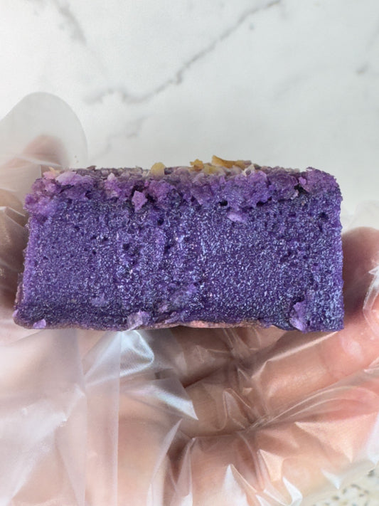 Close-up of ube coconut butter mochi cake bars showing the vibrant purple color and chewy texture.