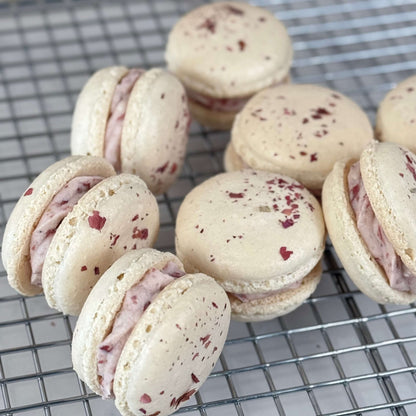 Organic Rose Macaron ingredients featuring 12 delicate, rose-infused confections on a cooling rack.