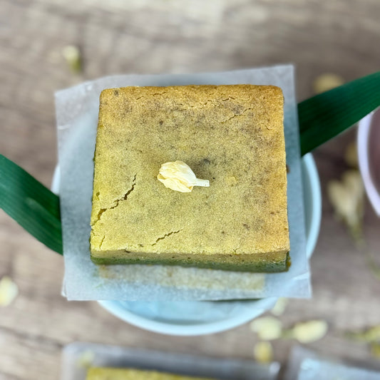Vegan Jasmine Matcha Mochi Cake Bar with delicate texture and jasmine garnish on a plate.
