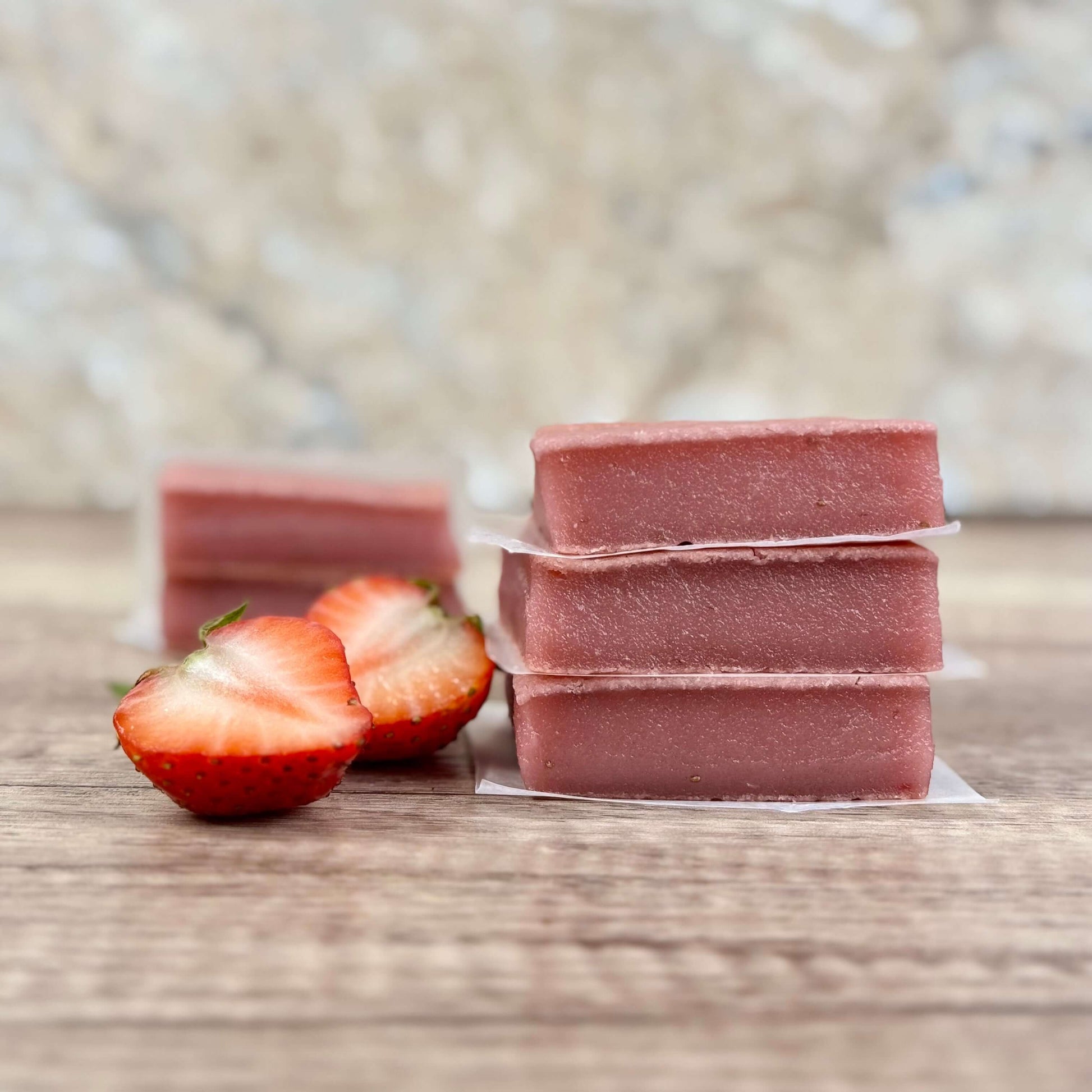 Vegan Strawberry Mochi Cake Bars stacked with fresh strawberries, showcasing their chewy texture and delicious flavor.