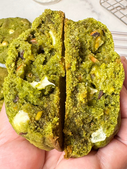Soft matcha cookie with roasted pistachios and white chocolate chunks, vibrant green color and nutty, sweet flavor blend.