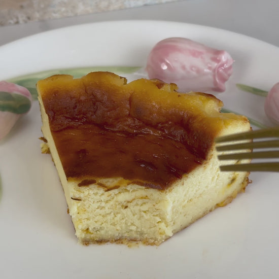Creamy burnt Basque cheesecake infused with tangy passion fruit, featuring a caramelized top and a silky, custard-like center with tropical flair.