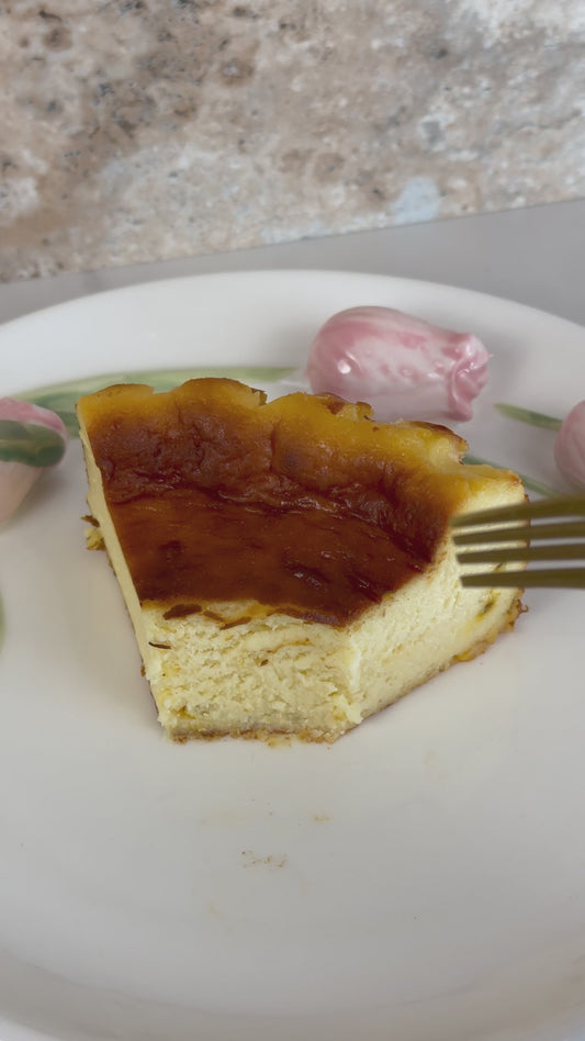 Creamy burnt Basque cheesecake infused with tangy passion fruit, featuring a caramelized top and a silky, custard-like center with tropical flair.